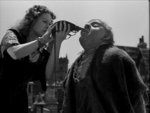 Esmeralda gives Quasimodo a drop of water (Maureen O'Hara, Charles Laughton) 1939 Hunchback of Notre Dame picture image