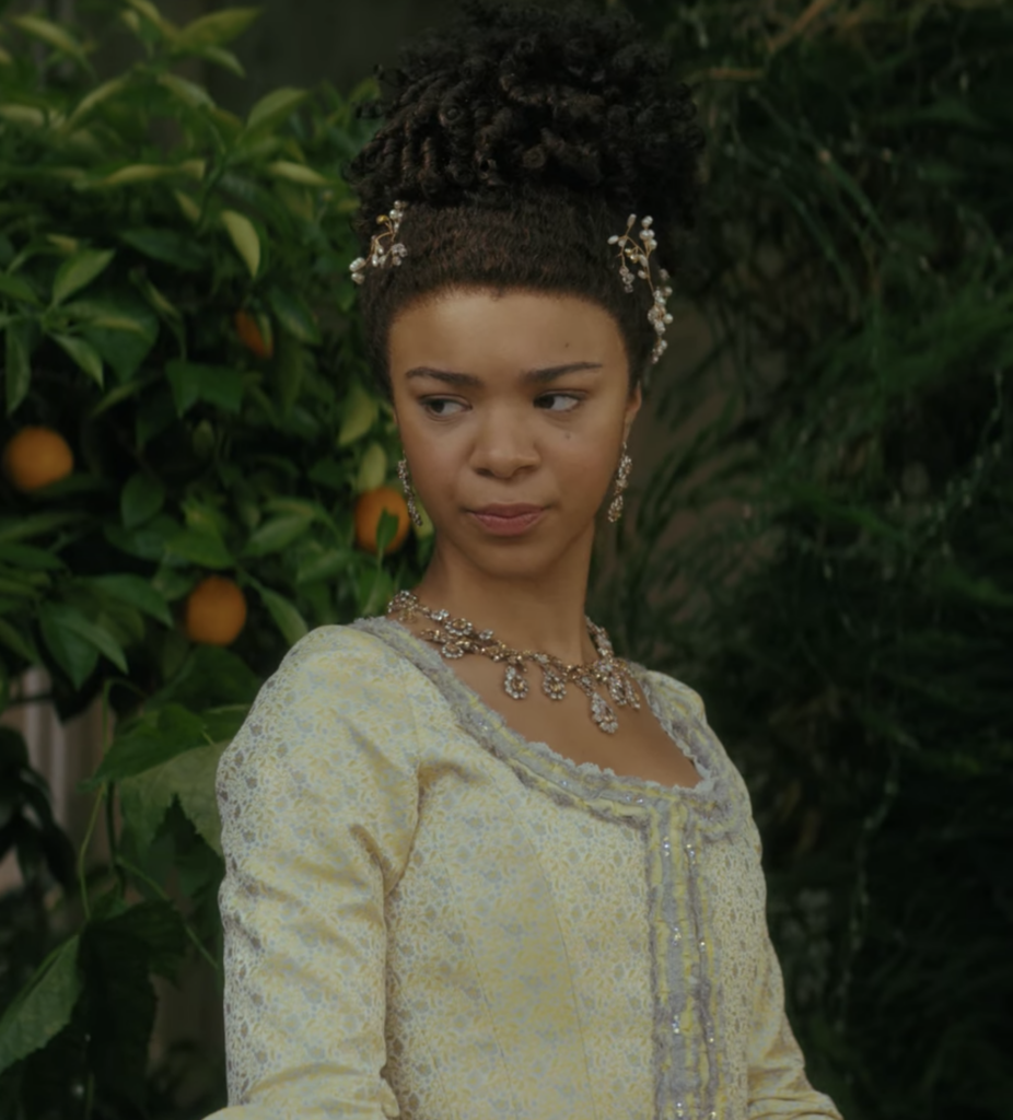 India Amarteifio as young Queen Charlotte in Netflix's “Queen Charlotte: A Bridgerton Story” yellow and gray dress