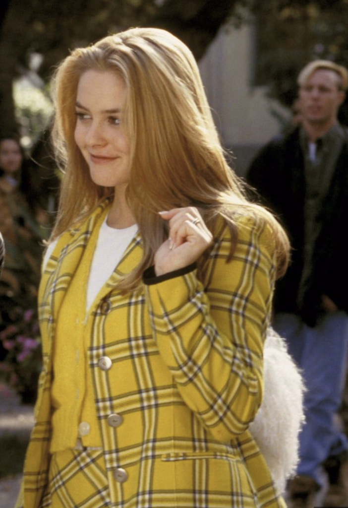 Alicia Silverstone in "Clueless" (1995) is absolutely iconic in her yellow plaid jacket and matching skirt suit, with yellow cardigan and white shirt underneath. Best Yellow Costumes, Gowns, & Dresses from Modern Set Movies