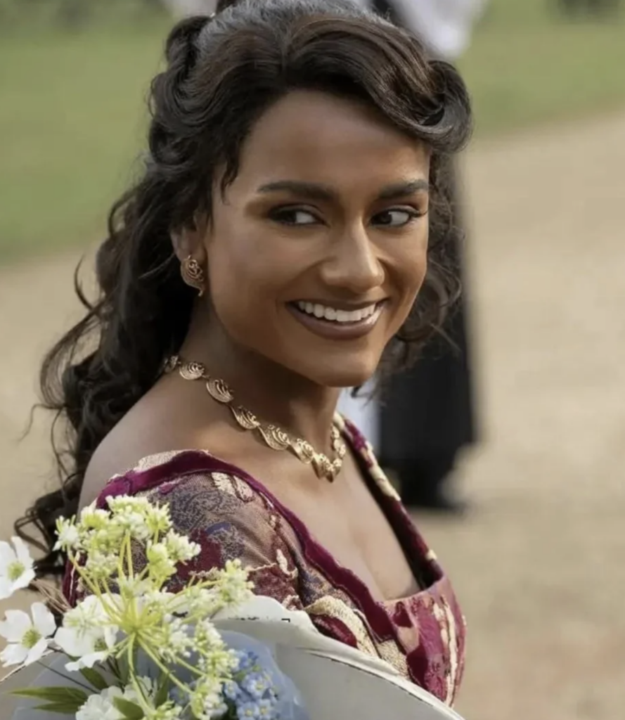 Simone Ashley as Kate Sharma Bridgerton, Season 4 "Bridgerton" (2020-2026), Best Costumes, Gowns, Dresses, and Outfits, Burgundy and Tan patterned Dress worn to Benedict's and Sophie's wedding