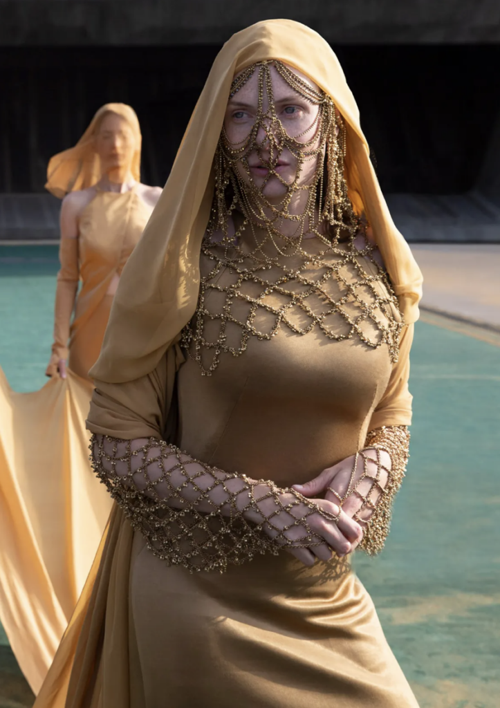 Rebecca Ferguson's sleeveless goldenrod gown and veil combination in 2021's "Dune" is one of the best yellow costumes in fantasy/sci-fi. Best Yellow Costumes, Gowns, & Dresses from Fantasy & Sci-fi Movies